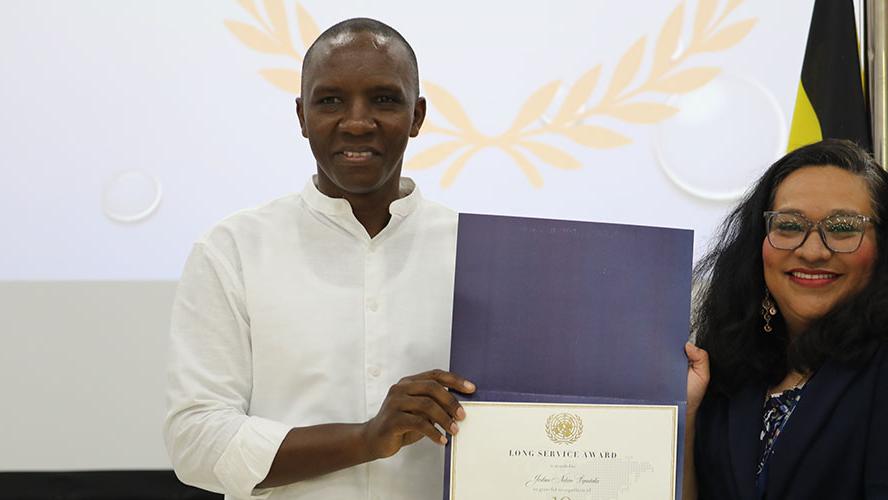 Joshua Byentaka (l) and RSCE Deputy Director, Nalini Contreras (r)