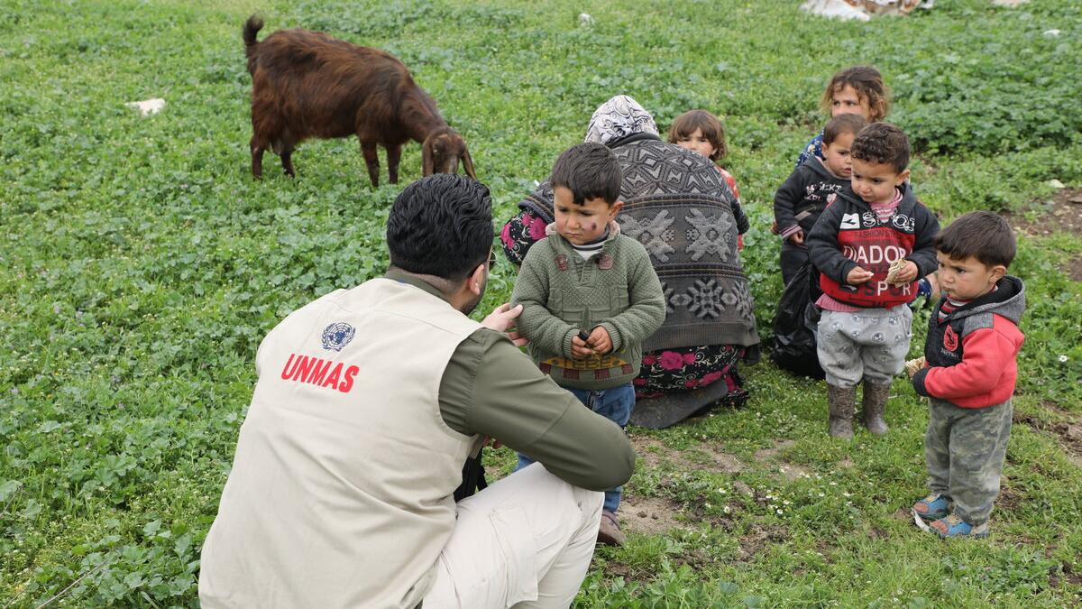 a man is talking to some children