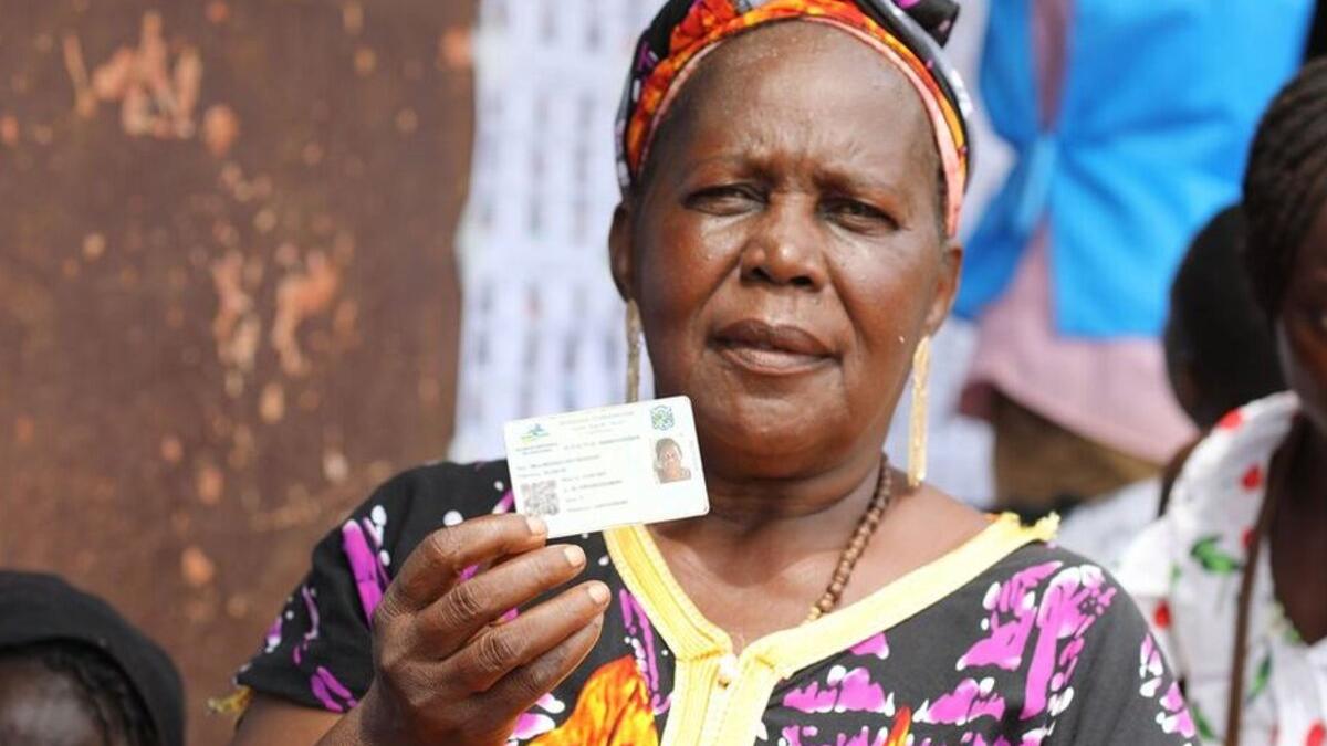 A voter in Central African Republic displays her ID.
