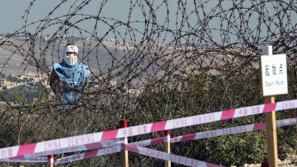 A Chinese deminer works along the Blue Line near Rmeish, south Lebanon.
