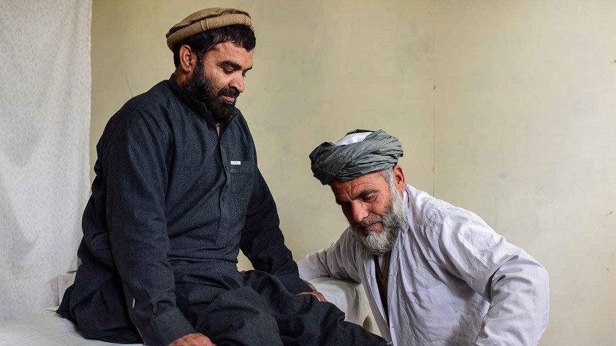 a doctor is conducting physical therapy to a mine victim