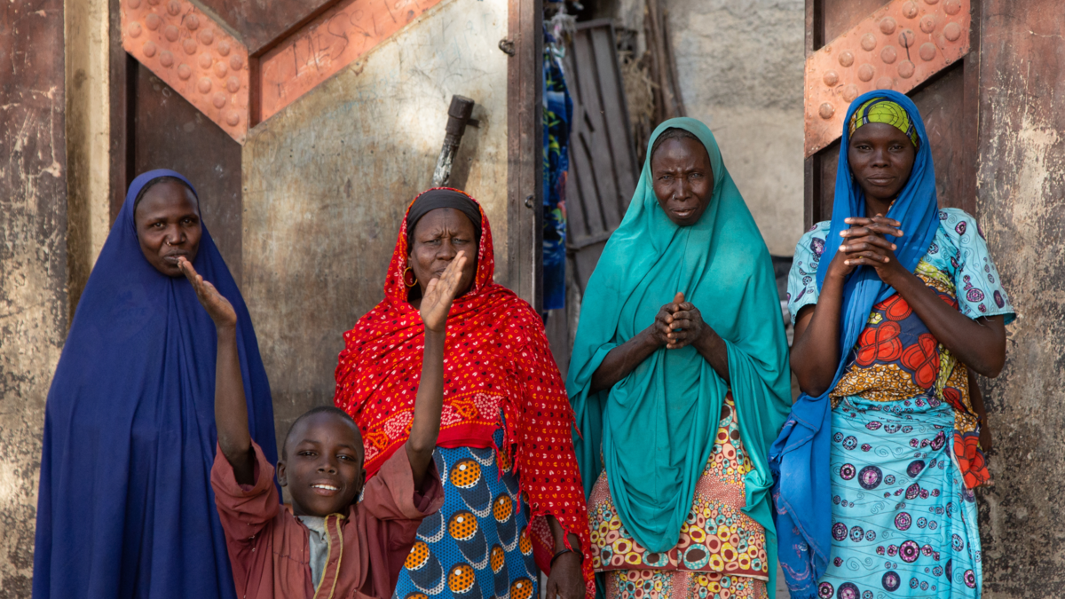 Children waving goodbye to the UNMAS team at the end of their Explosive Ordnance Risk Education session, showing some of the information, education and communication materials distributed by the UNMAS teams.
