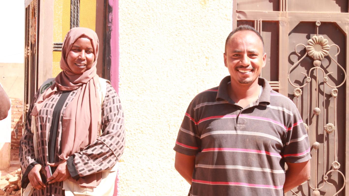 Mr. and Mrs. Ibrahim smile, relieved from the fear of explosive hazard in their yard