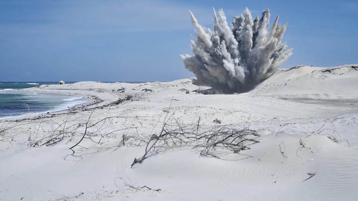 an explosion with smoke in a field