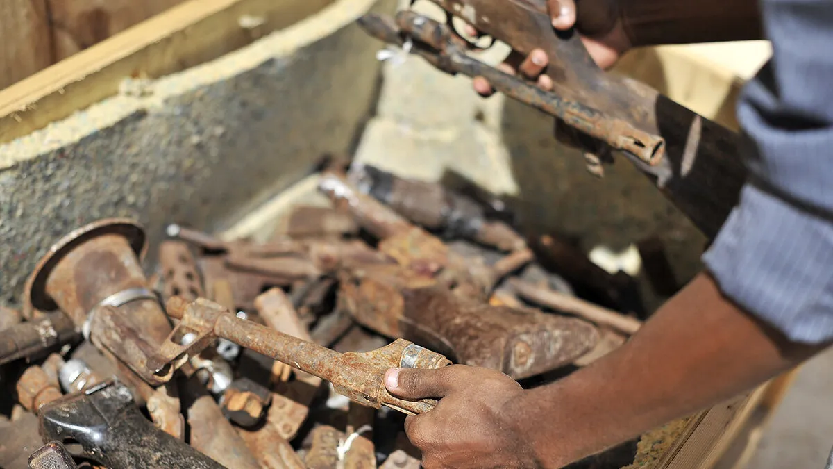 A Somali security officer inspects destroyed obsolete guns during a training of weapons destruction in Mogadishu, Somalia. The training was supported by the United Nations Assistance Mission in Somalia (UNSOM) and conducted by UNMAS.