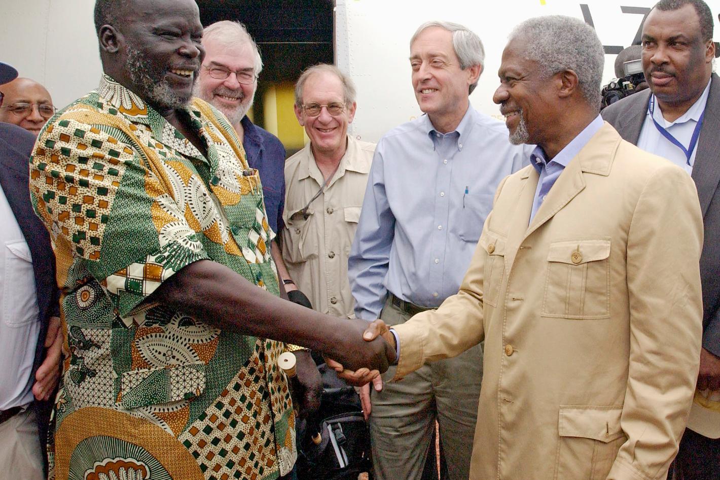 John Garang (left), Chairman of the Sudan People's Liberation Movement (John Garang ), welcoming Secretary-General Kofi Annan upon his arrival in Rumbek, southern Sudan.