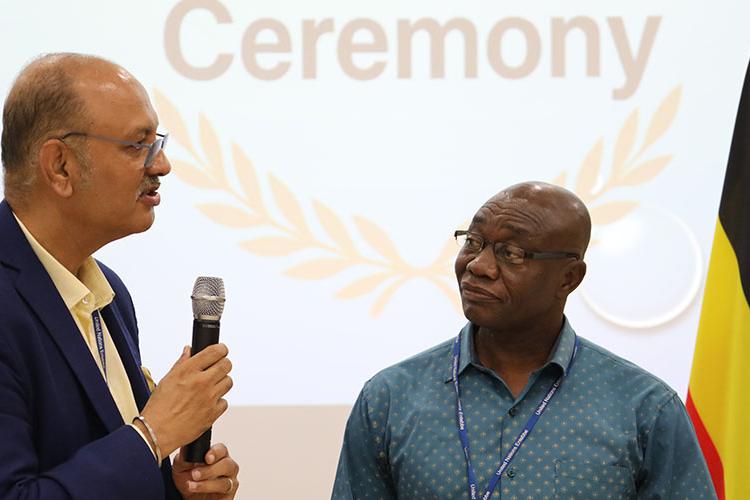 Chief FSDH, Sanjay Khanna (l) delivers his appreciation of James Nsoh's (r) dedication and work ethic.