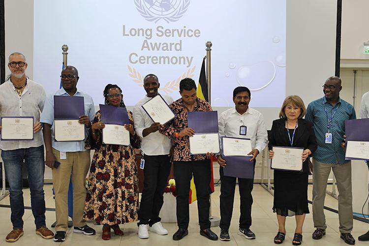 Photo of the recipients of the SG's Long Service Awards posing with their certificates at the RSCE