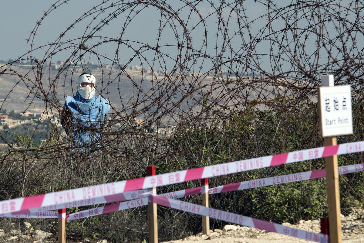 A Chinese deminer works along the Blue Line near Rmeish, south Lebanon.