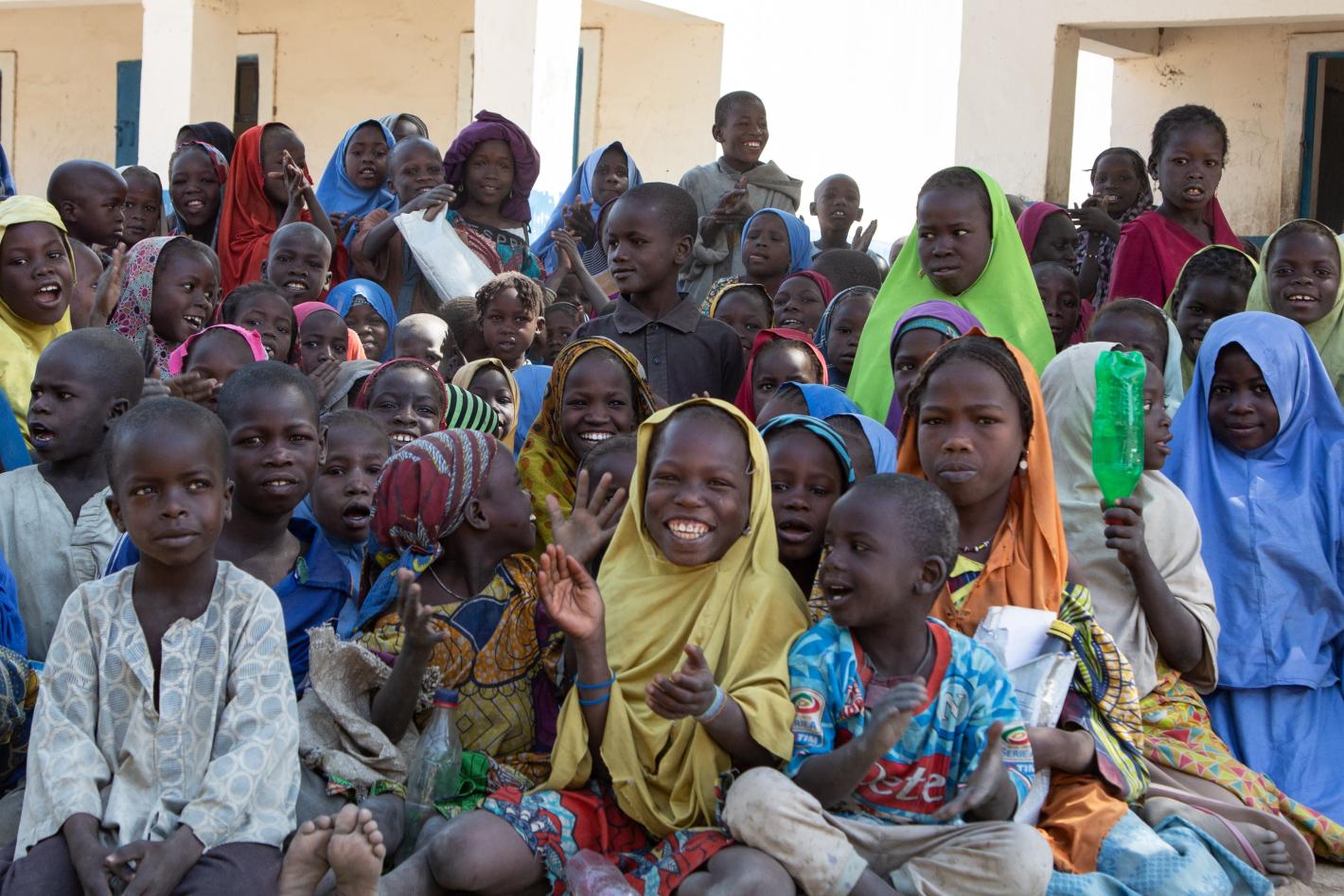 many children are sitting on the floor