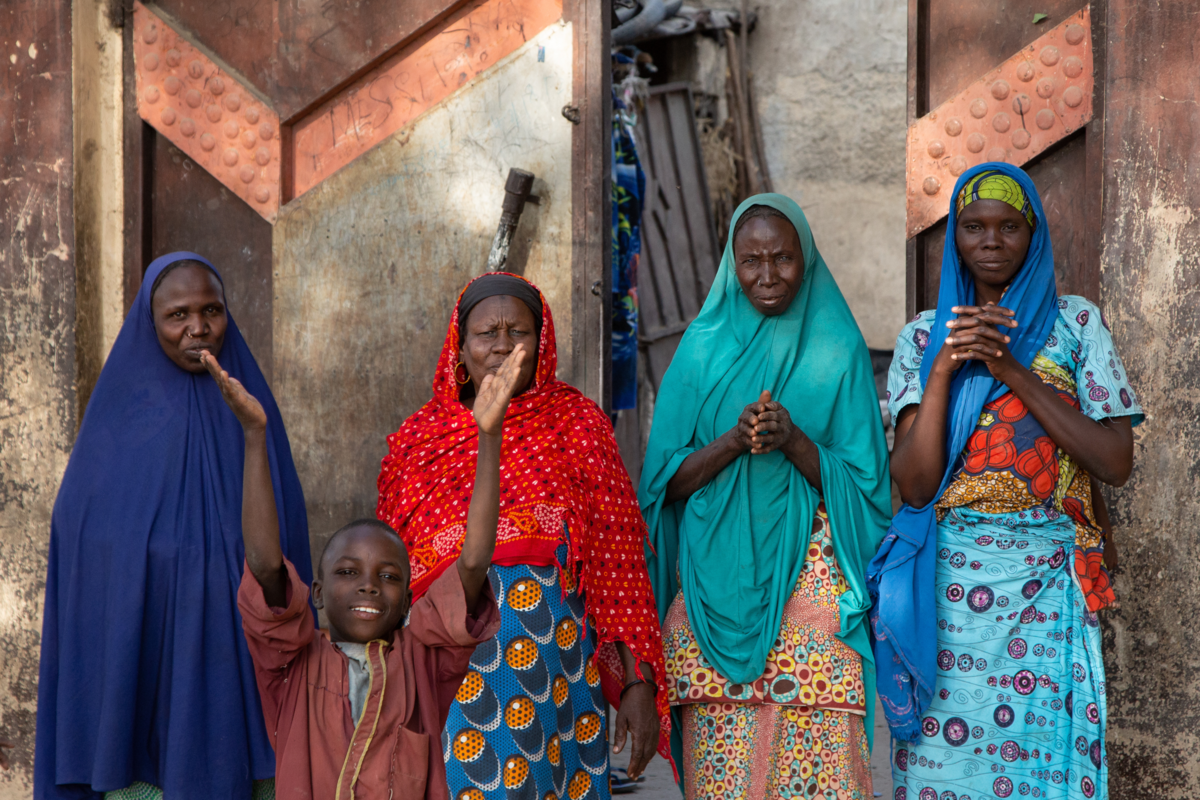 Children waving goodbye to the UNMAS team at the end of their Explosive Ordnance Risk Education session, showing some of the information, education and communication materials distributed by the UNMAS teams.