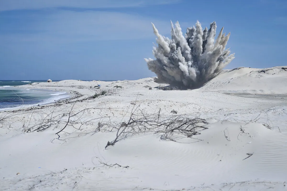 an explosion with smoke in a field