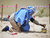 A female member of an Explosive Ordnance Disposal team brushes sand off of a mortar shell during a demonstration held by UNMAS in Mogadishu, Somalia. UN Photo/Tobin Jones