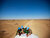 Peacekeepers with the UN Mission for the Referendum in Western Sahara (MINURSO) consult a map as they drive through vast desert areas in Smara, Western Sahara. UN Photo/Martine Perret