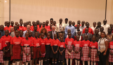 A group of children with red shirts are standing together