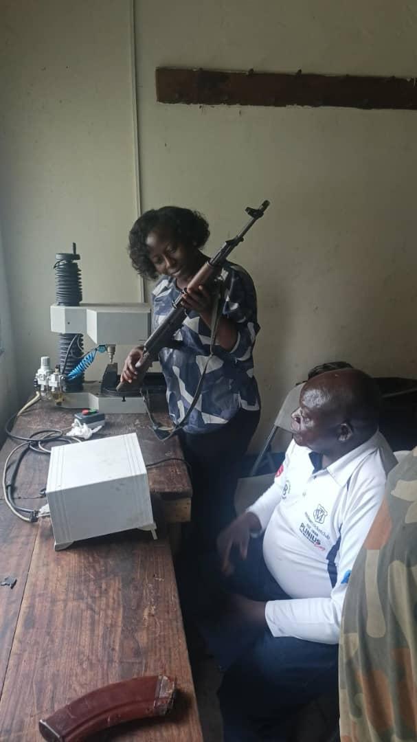 a woman is holding a gun