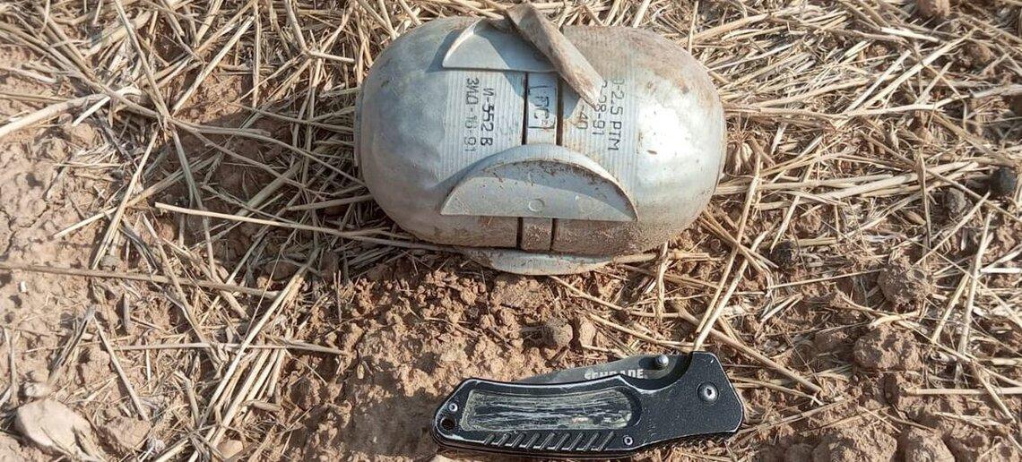 An unexploded bomb sits on the ground