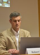A man sitting in front of a laptop